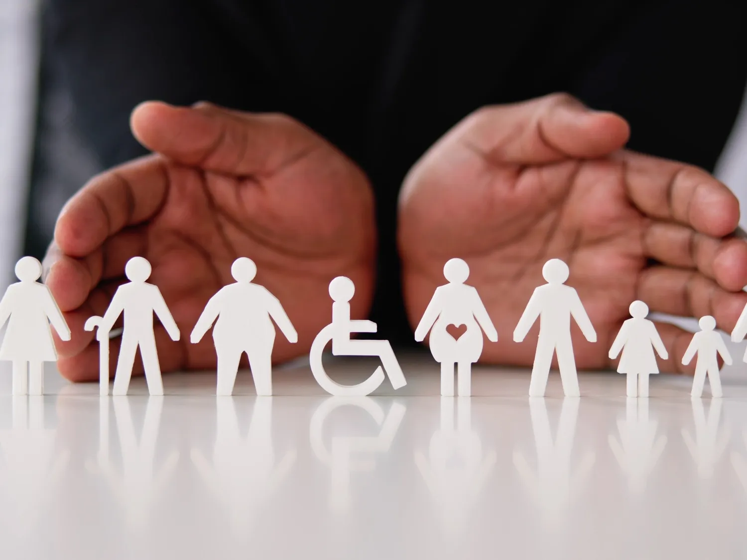 woman pushing a man in wheelchair